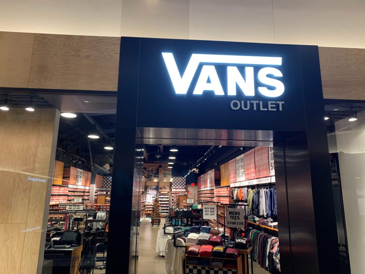 A van 's outlet store front with many items on display.