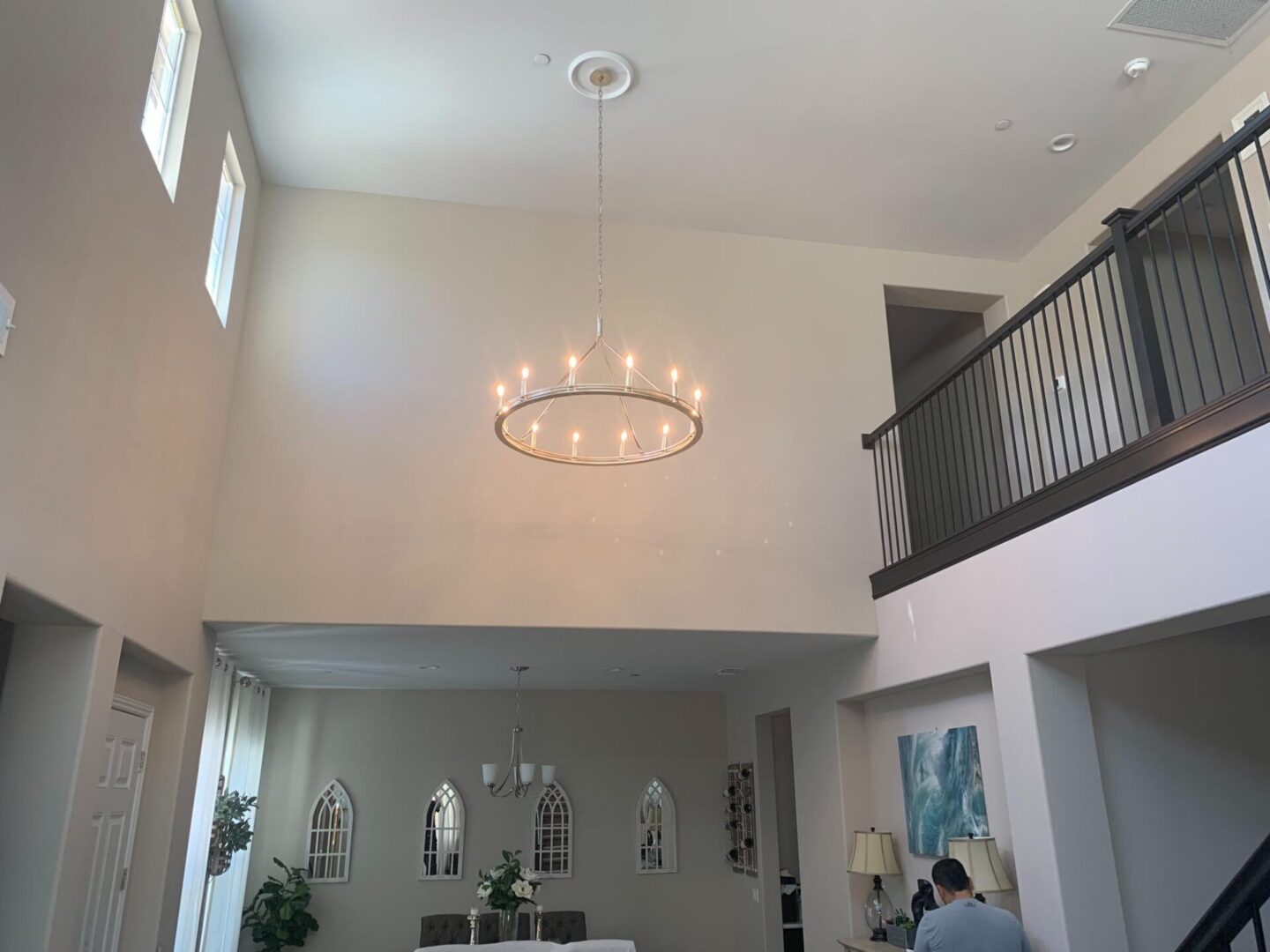 A large room with two floors and a chandelier.