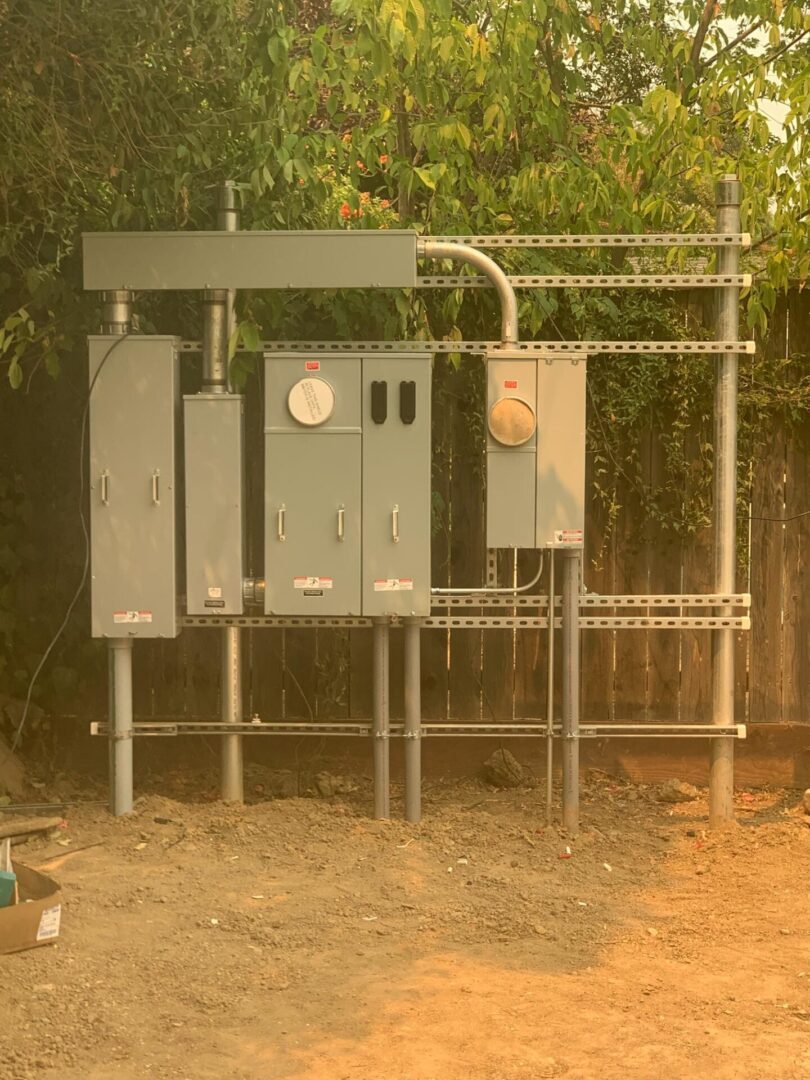 A metal structure with electrical boxes on it.