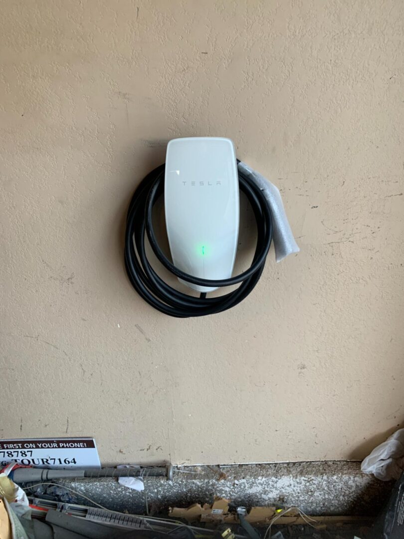 A white wall mounted electric car charger.