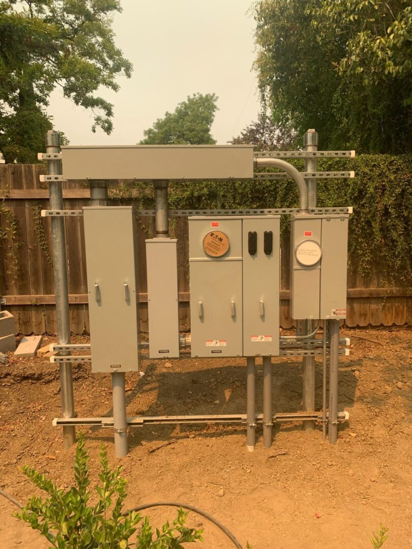 A metal structure with electrical boxes on top of it.