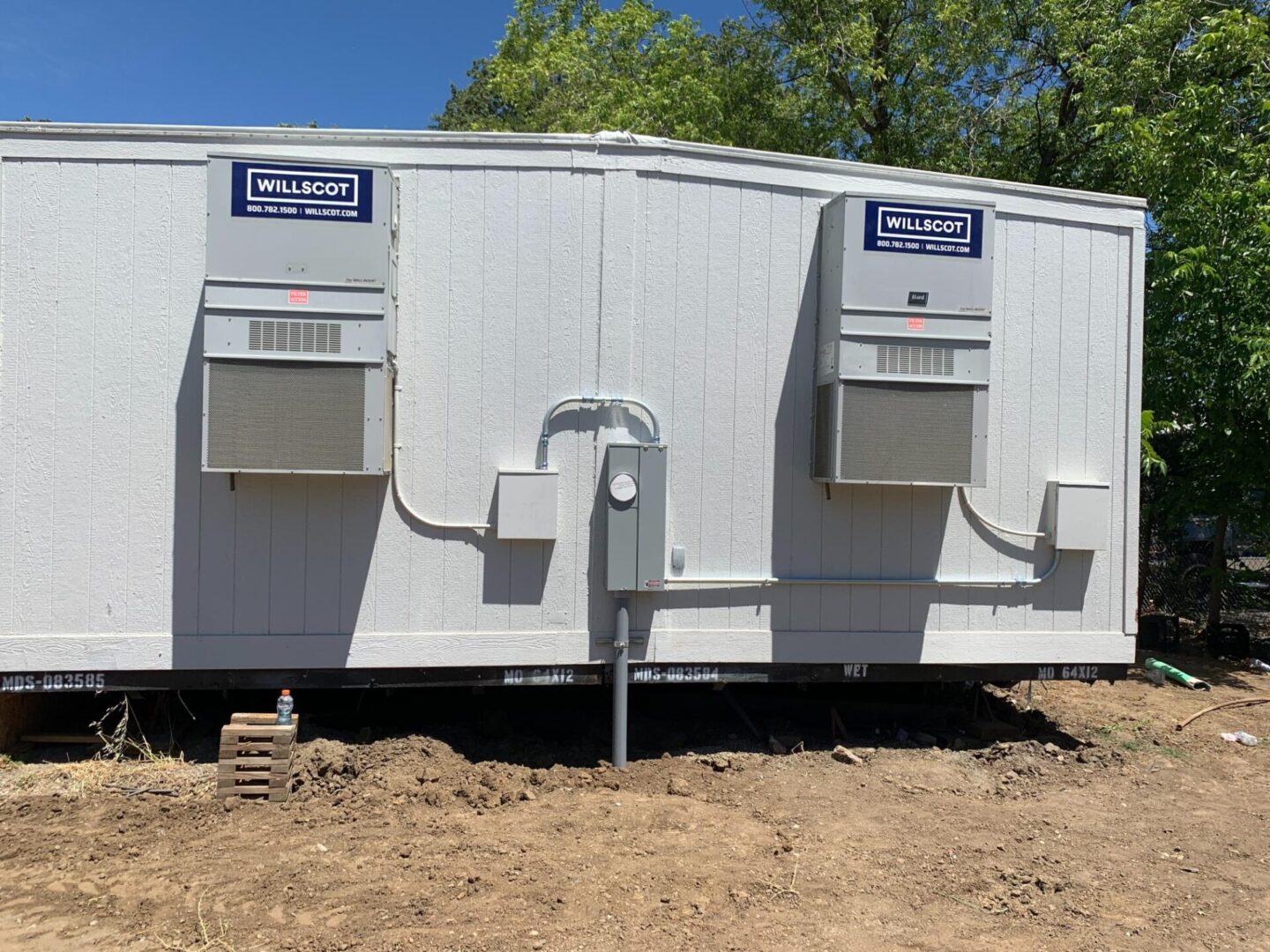 A white trailer with two vents on the side.