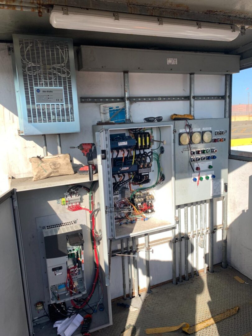 A view of an electrical panel and the outside of a building.