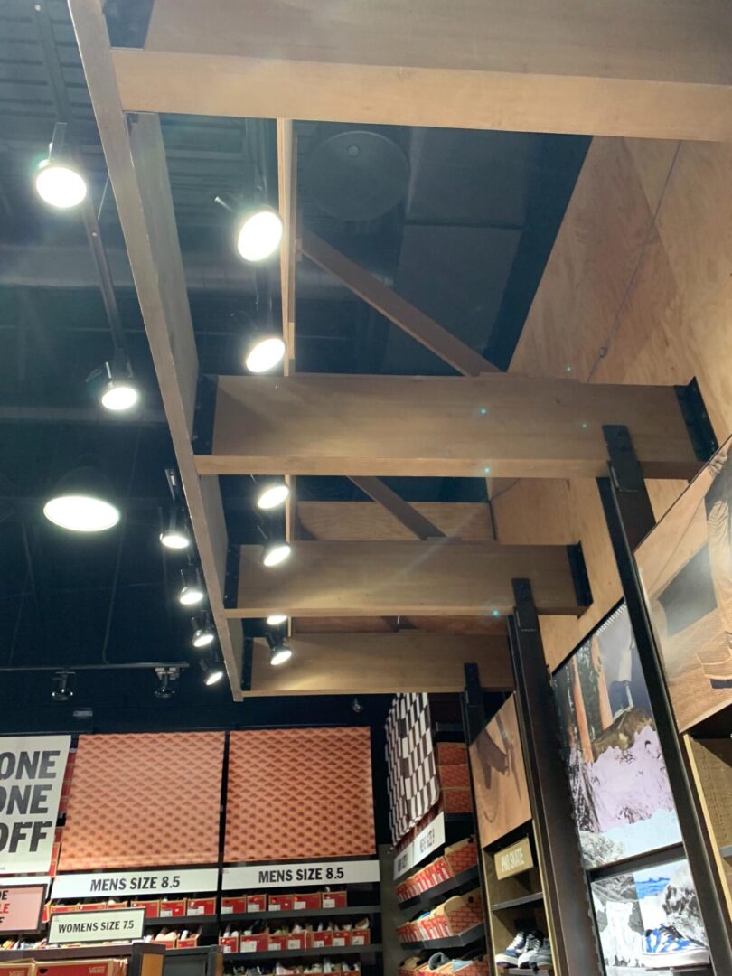 A ceiling with some lights and wood beams