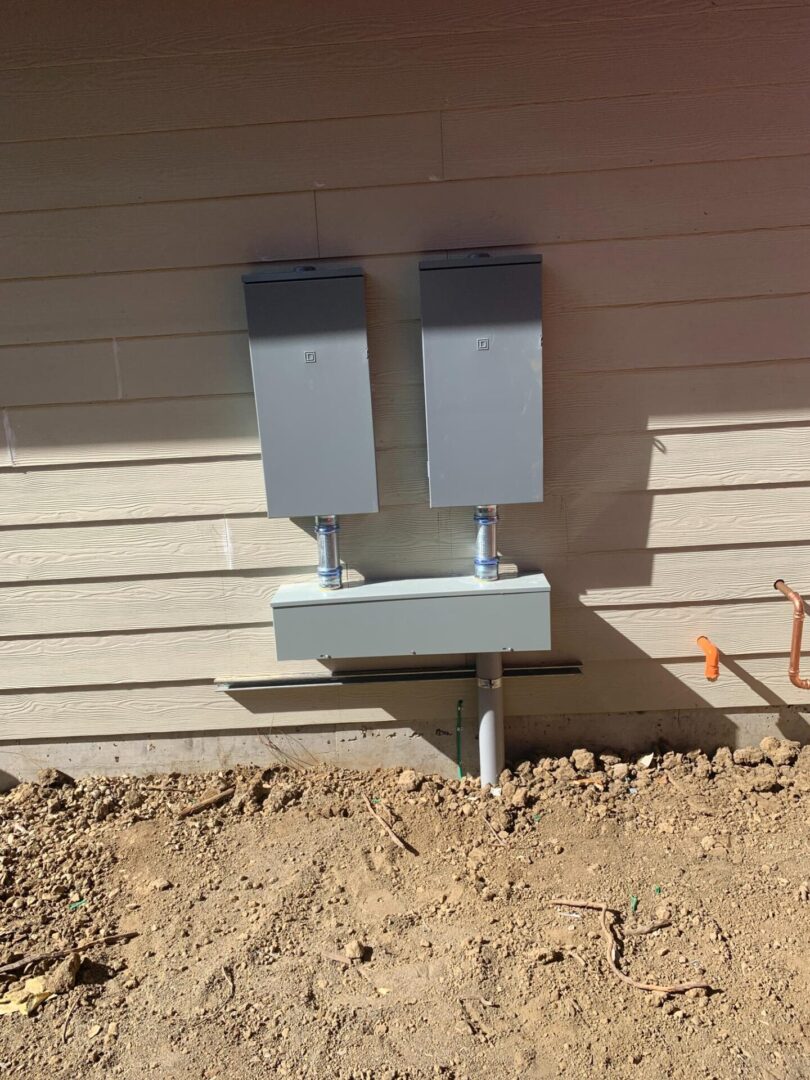 A wall with two electrical boxes on it