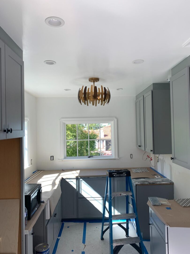 A kitchen with a table and cabinets in it