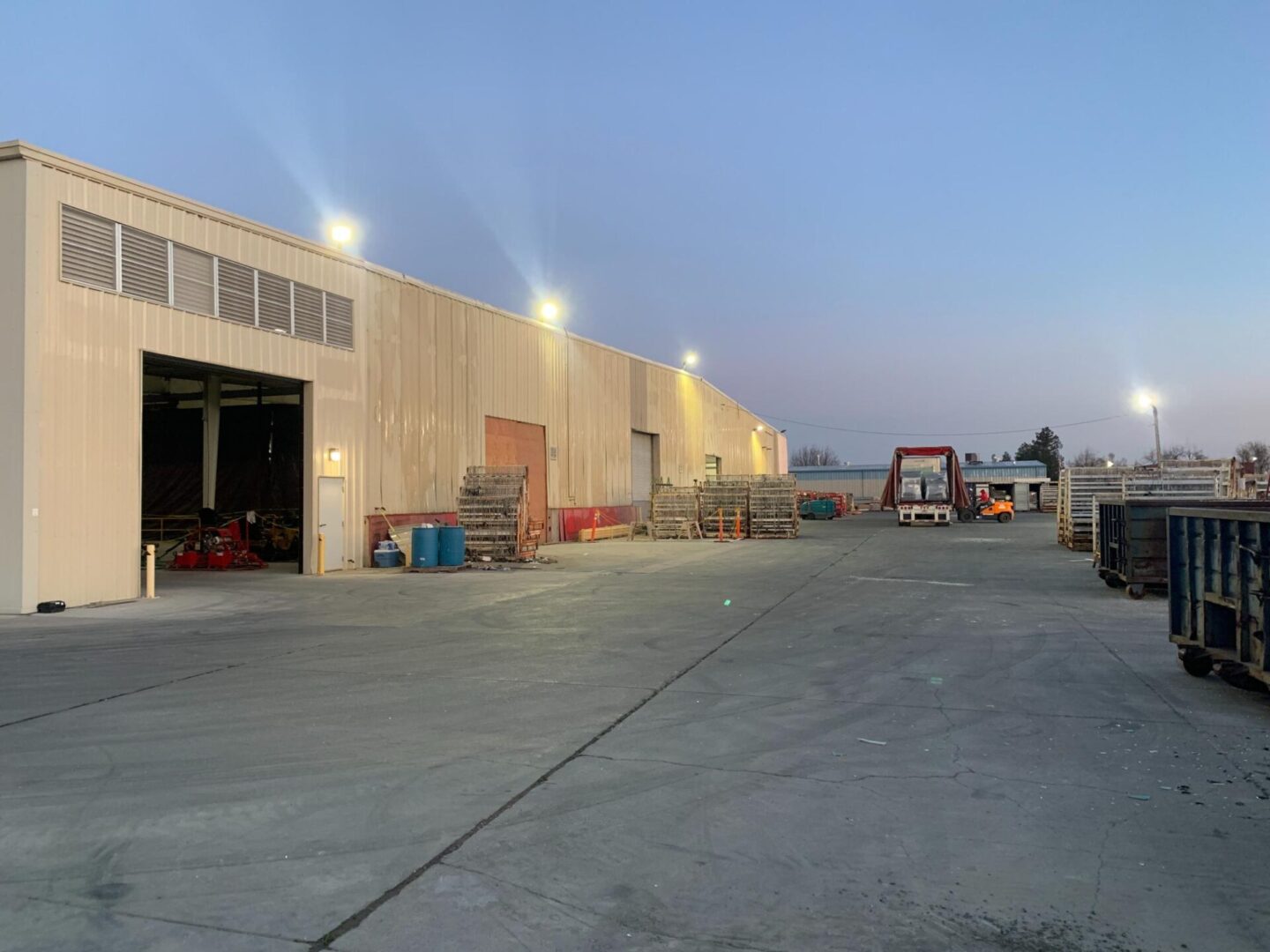 A large warehouse with many lights on the side of it.