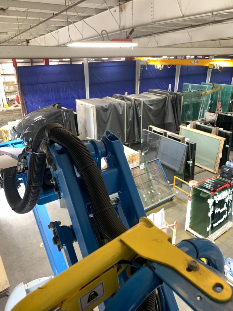 A machine in a factory with many glass windows