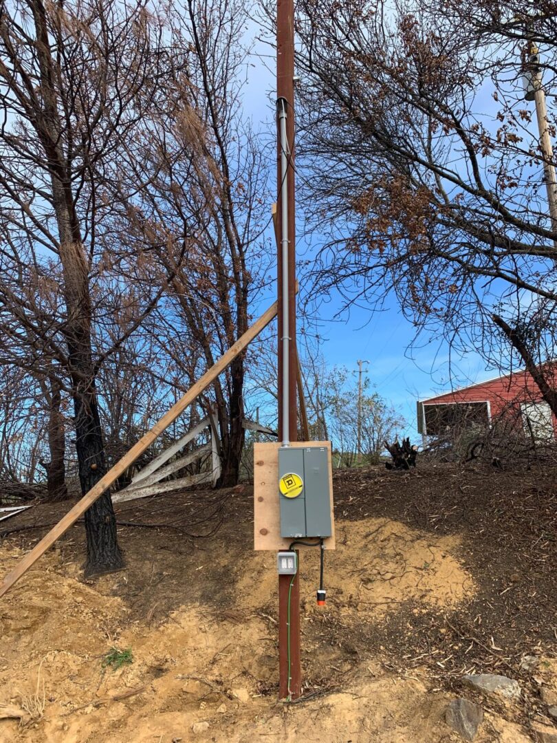 A wooden pole with a yellow sign on it