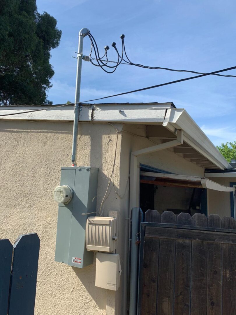 A house with electrical wires hanging from the roof.