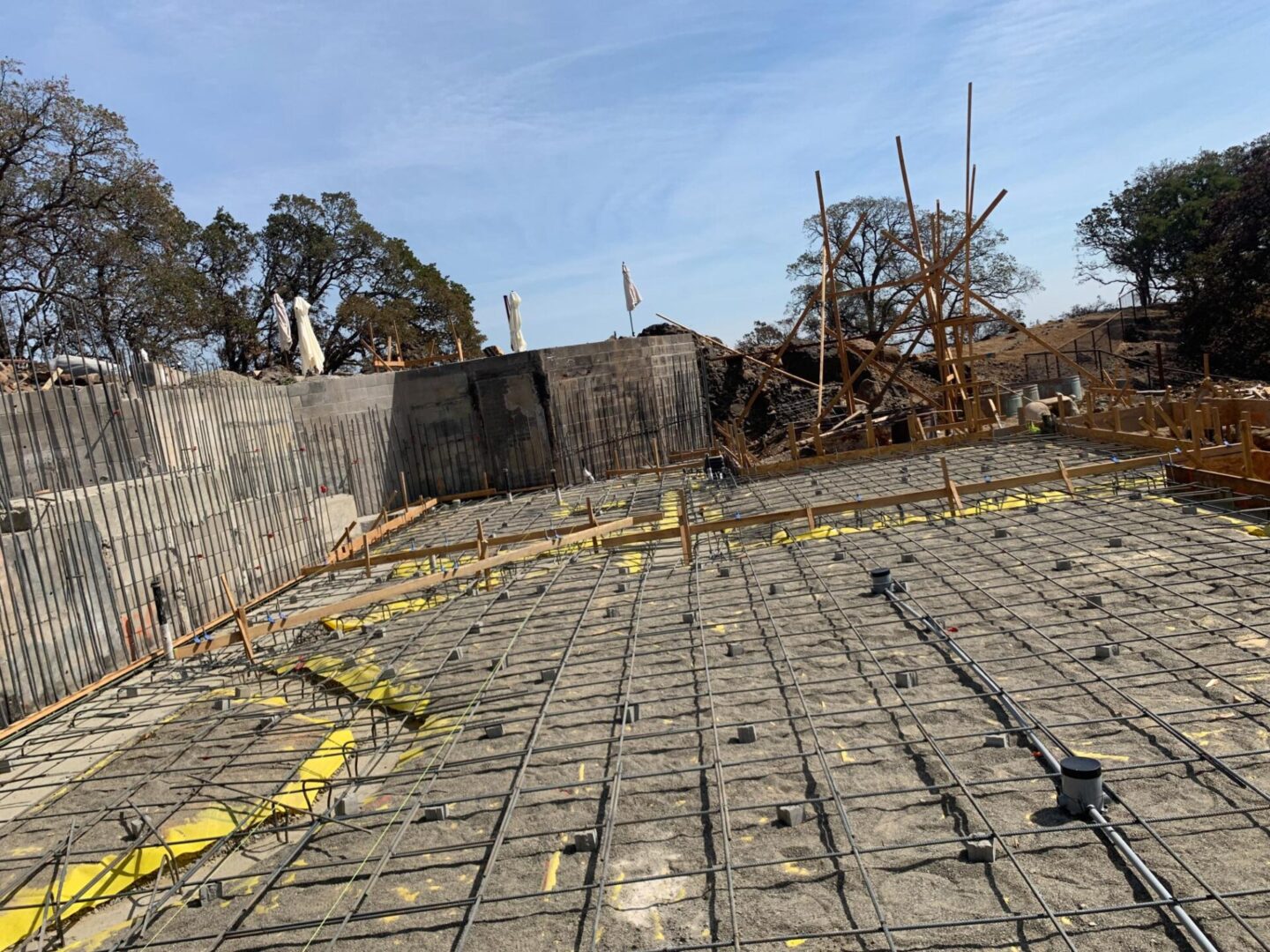 A concrete slab with yellow tape on it.