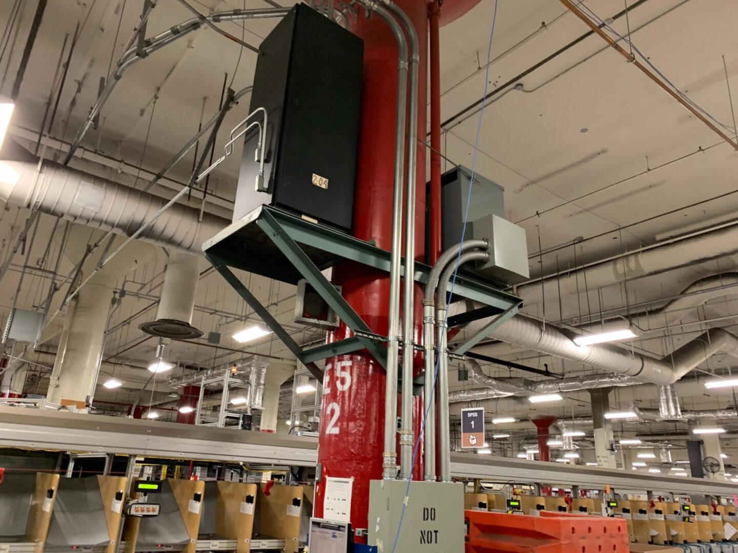 A red pole with two speakers on it